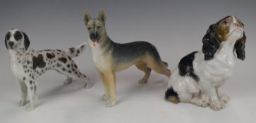 Three Royal Copenhagen and Bing & Grondahl models of dogs comprising standing setter in grey