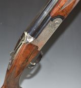 Rizzini 12 bore over and under ejector shotgun with all over scrolling engraving, chequered semi-