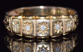 An 18ct gold ring set with five diamonds in star settings, 5.1g, size T