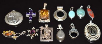 Twelve silver pendants including amber, turquoise, coral, etc