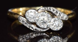 An 18ct gold ring set with three diamonds in a platinum twist setting, 2.9g, size M