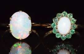 Two 9ct gold rings, one c1920 set with an opal cabochon and the other set with opal and emeralds,