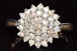 A 9ct gold ring set with a cluster of diamonds, 4g, size P