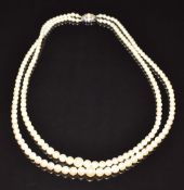 A double strand cultured pearl necklace, the 9ct white gold clasp set with a pearl