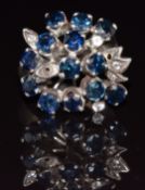 An 18k white gold ring set with sapphires and topaz, 5.4g, size J