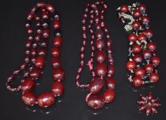 Three cherry amber necklaces and a cherry amber brooch, 150g