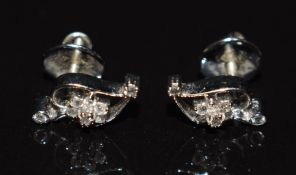 A pair of 18k white gold earrings set with diamonds in a floral cluster, 2.6g