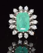 An 18ct white gold ring set with an emerald cut emerald of approximately 3ct surrounded by