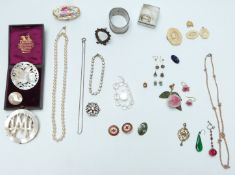 A collection of jewellery including mother of pearl brooches, c1900 silver paste buckle, bone