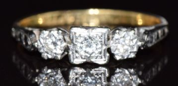An 18ct gold ring set with three diamonds in a platinum setting, 2.3g, size K
