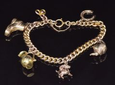 A 9ct gold charm bracelet with six 9ct gold charms including teapot, boot, goat, horseshoe, etc,
