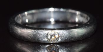 A platinum ring set with a diamond of approximately 0.1ct, 7.4g, size Q