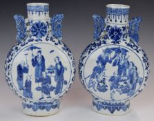 Pair of 19thC Chinese twin handled blue and white moon flasks, each decorated with four separate