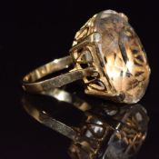 An 18ct gold ring set with an oval quartz, 7.6g, size I