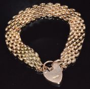 A c1910 9ct rose gold bracelet with textured links and heart padlock clasp, 20g, 19cm long