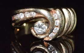 An 18ct gold ring set with diamonds in a curved setting, 5.8g, size P