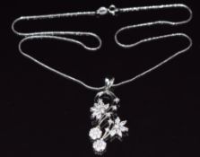 An 18k white gold necklace set with cubic zirconia in a scrolling floral design, 8.4g, 40cm long