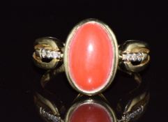 A 14k gold ring set with a coral cabochon and diamonds to the shoulders, 4.6g, size N