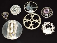 Six silver brooches including a Scottish Robert Allison brooch set with an amethyst and a silver