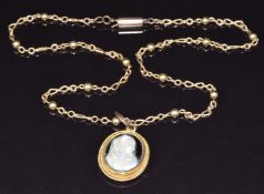 A c1900 15ct gold pendant set with an agate cameo (5g) on 9ct gold chain made up of sphere and cross
