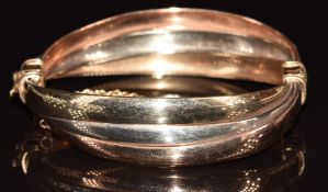 A 9ct gold tri-coloured bangle, 16.1g, 5 x 5.5cm