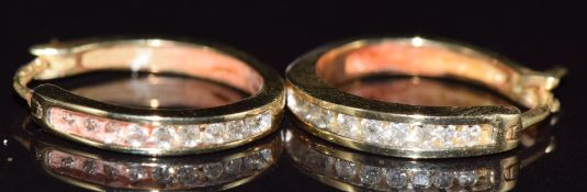 A pair of 9ct gold earrings set with diamonds, 2.3g