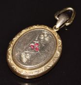 Victorian yellow metal locket set with garnets and seed pearls