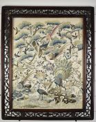 19thC Chinese embroidery of birds, flora and fauna in an openwork hardwood frame, 53 x 41cm