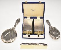 Cased pair of Art Deco style hallmarked silver backed brushes, London 1966, maker's mark TP,