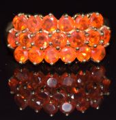 A 9ct gold ring set with round cut fire opals in three rows, 3.5g, size N