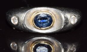 An 18ct white gold ring set with a sapphire and diamonds, 4.5g, size M