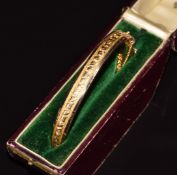 A 9ct gold bangle with foliate decoration, Birmingham 1905, in original box 'W.Dodds, 7 Eastgate,