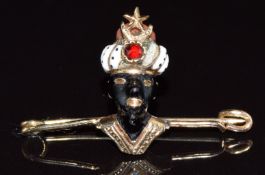 A 19thC gold brooch in the form of a blackamoor figure set with enamel, coral and garnet, 3.7g, 3cm