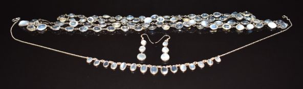 Two silver necklaces set with moonstone cabochons and a pair of silver earrings set with moonstones