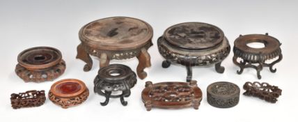 Nine 19th/20thC Chinese carved hardwood stands, largest height 11x diameter 18cm