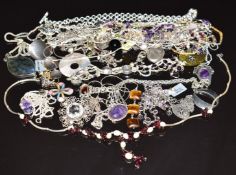 A collection of silver necklaces including amethyst, pearl, tiger's eye, peridot, etc
