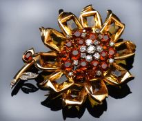 A c1930's Cartier brooch in the form of a sunflower set with old mine cut diamonds to the centre