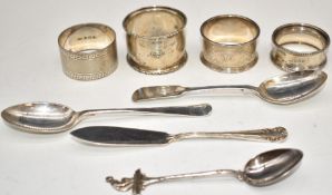 Four various hallmarked silver napkin rings, two hallmarked silver teaspoons and a hallmarked silver