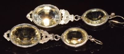 A pair of Victorian yellow metal earrings set with oval cut citrines, with fish decoration to the