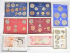A collection of coin sets in perspex presentation packs and blocks, includes banknote examples