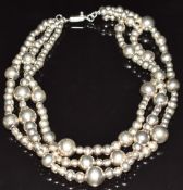 A three strand beaded silver necklace