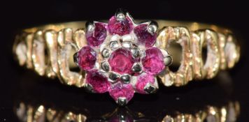 An 18ct gold ring set with rubies in a cluster, 2.5g, size M