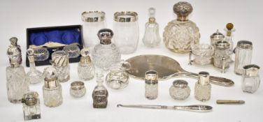 Twenty one silver mounted dressing table bottles, vases and salts including a cased pair of salts