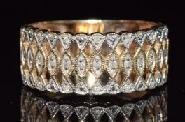 A 9ct gold ring set with diamonds in a pierced lattice setting, 5.3g, size W/X