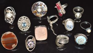 Thirteen silver rings including millefiori examples, one marked Finland, agate, abalone and pearl,