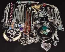 A collection of silver necklaces/ chains including amethyst, fish, St Christopher, etc
