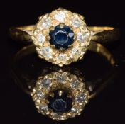 An 18ct gold ring set with a sapphire and diamonds, 3.1g, size M