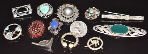 A collection of silver brooches including Arts & Crafts, Charles Horner, Victorian garnet, etc