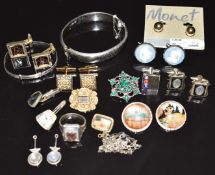 A collection of jewellery including Victorian mourning brooches, one set with a hand holding a coral
