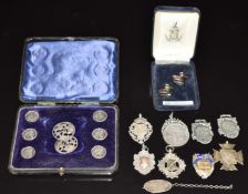 A pair of silver name card holders in the form of ducks, seven silver fobs including Tofrek Bull